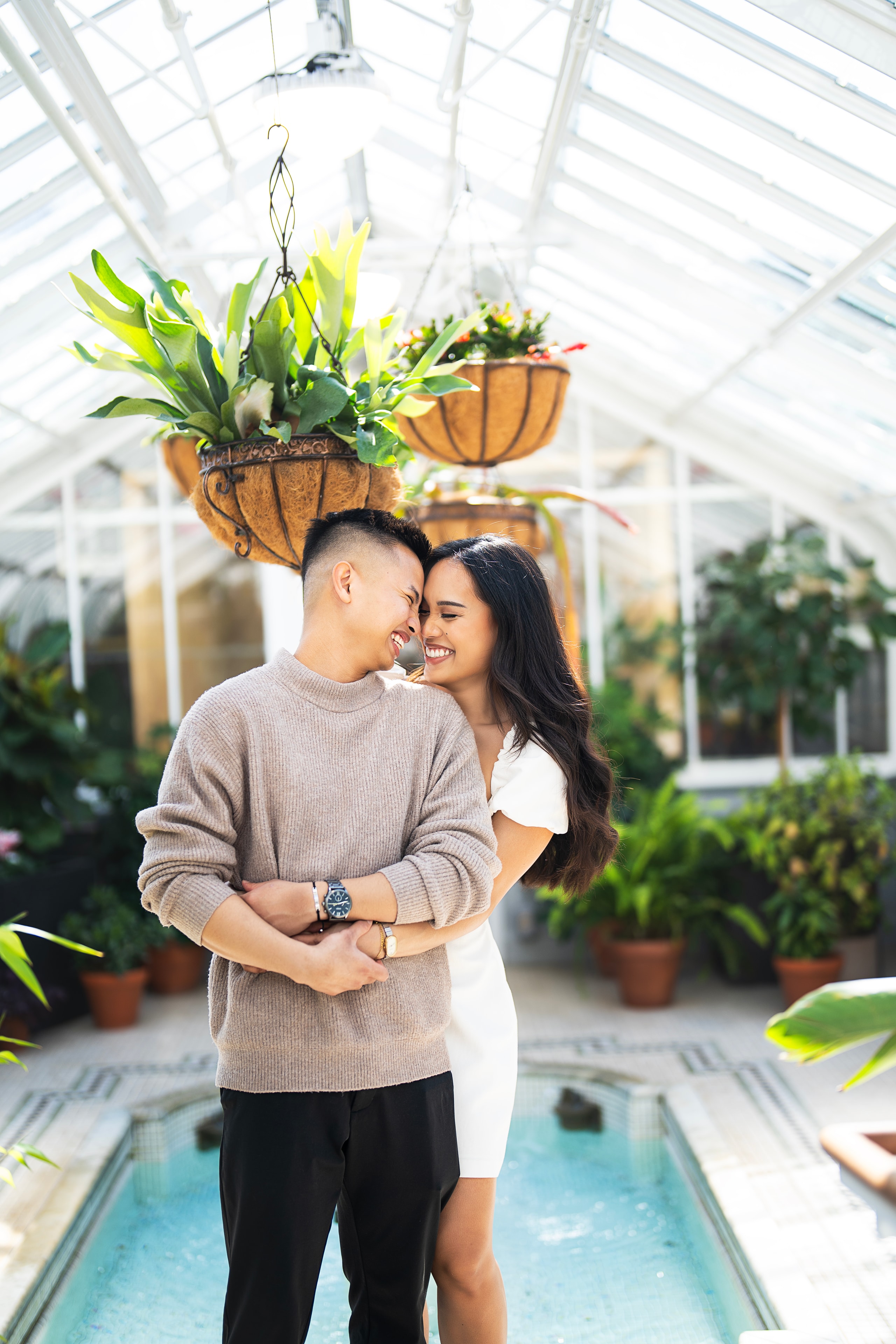 engagement couple laughing greenhouse botanical garden